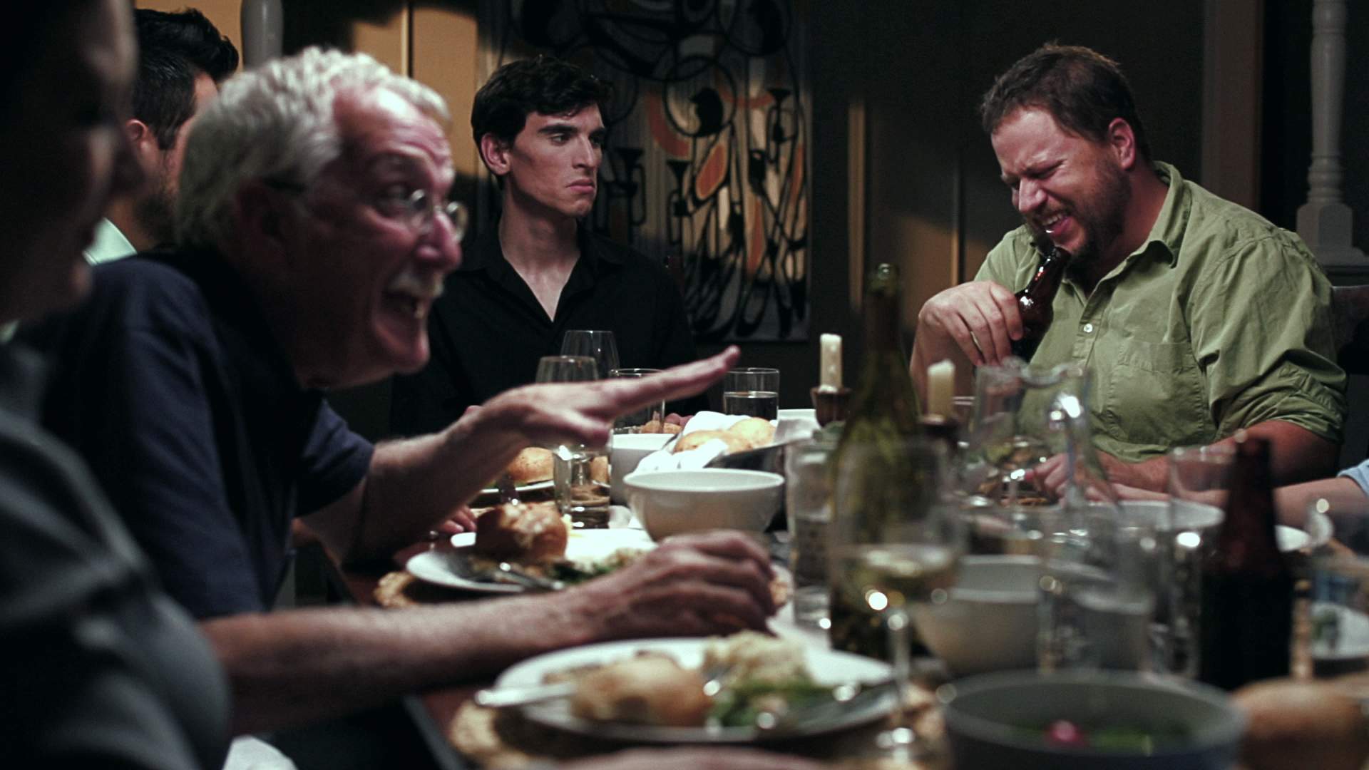 Film still. Dinner table conversation